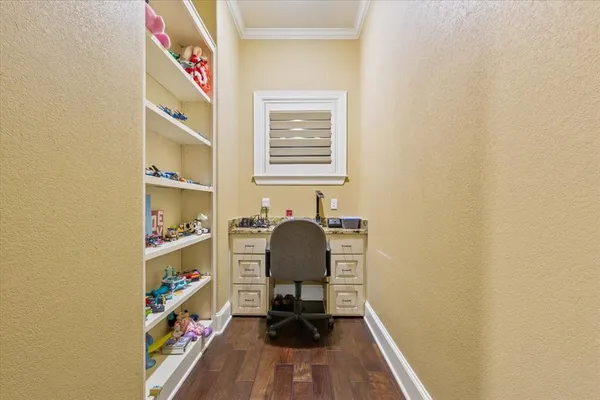a view of a workspace with furniture and wooden floor