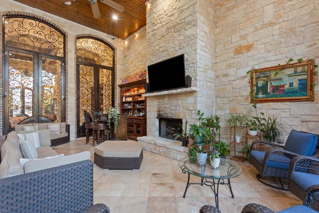 10020 Hidden Bluff Waco, TX 76657 - Photo 33 of 39 a living room with furniture a flat screen tv and a fireplace