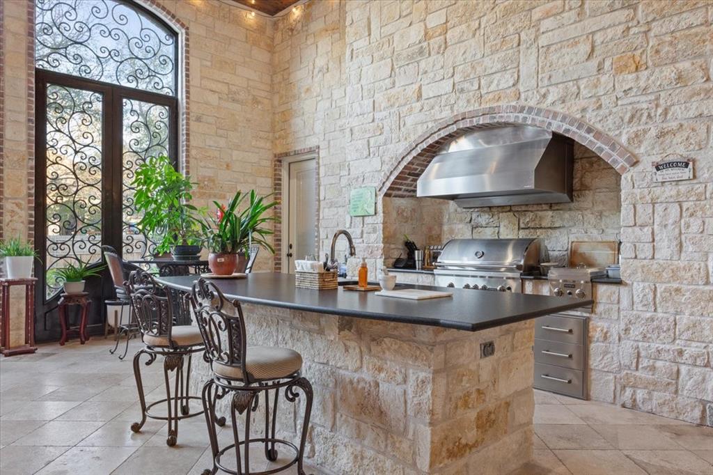 10020 Hidden Bluff Waco, TX 76657 - Photo 33 of 40 a kitchen with a stove a table and chairs in it