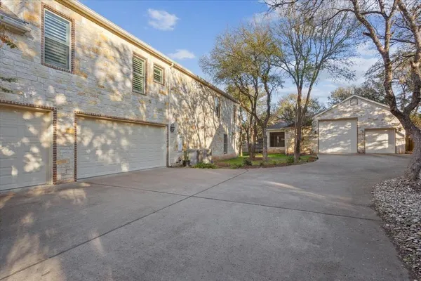 a backyard of a building with large trees