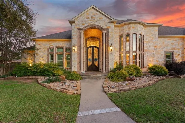 a front view of a house with a garden