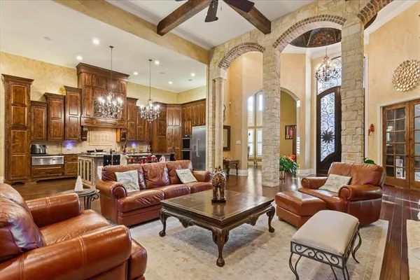 a living room with furniture and a chandelier