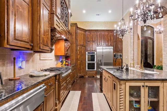 a kitchen with stainless steel appliances granite countertop a stove and a sink