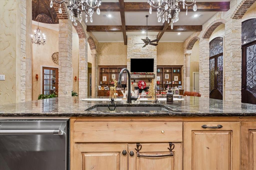 10020 Hidden Bluff Waco, TX 76657 - Photo 9 of 39 a kitchen with kitchen island granite countertop a sink stainless steel appliances and cabinets