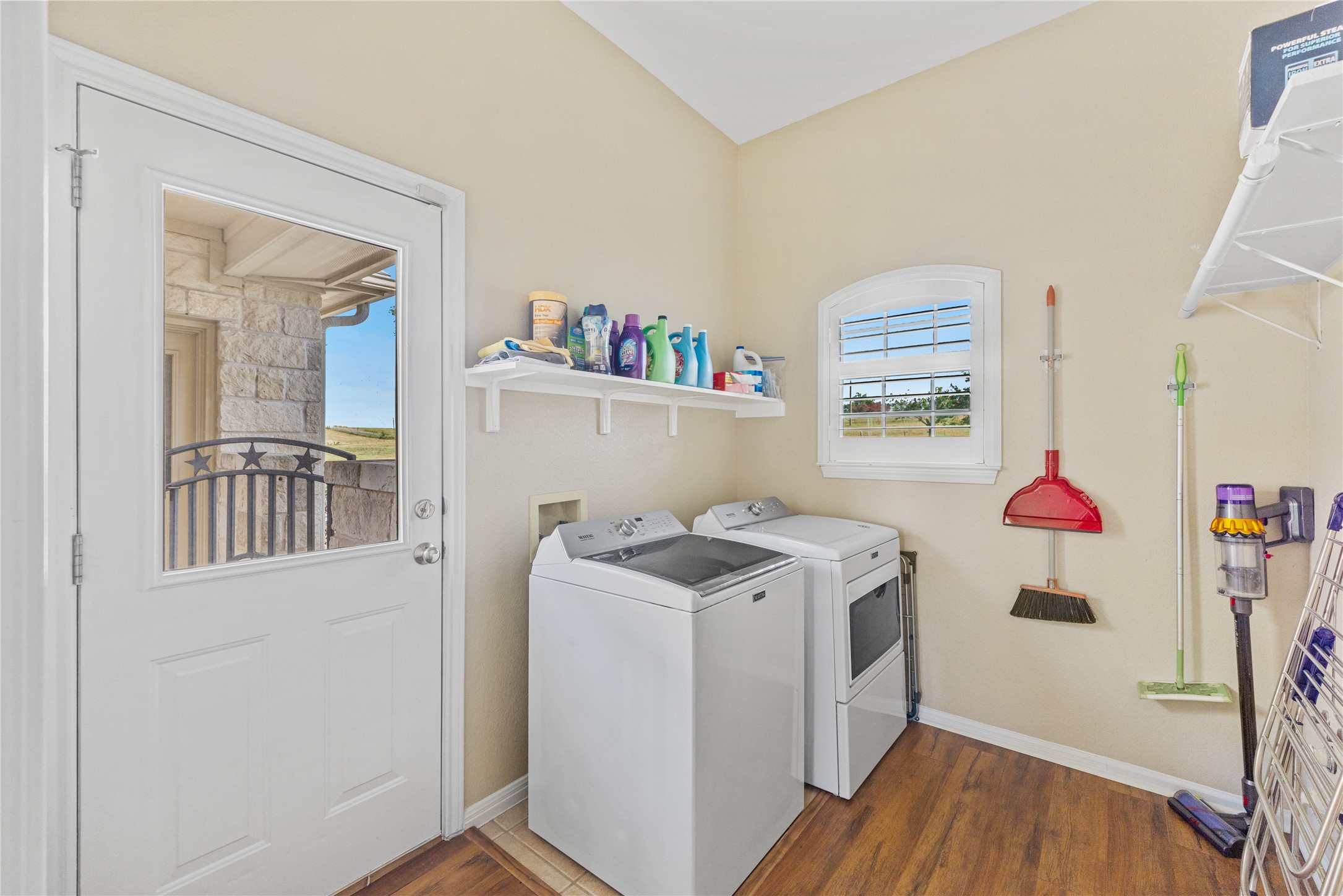 20145 Janak Road Coupland, TX 78615 - Photo 25 of 40 Functional laundry room featuring a convenient window and durable wood flooring.