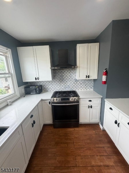 166 Renner Avenue, Unit 3 Newark, NJ 07112 - Photo 8 of 24 a kitchen with a sink stove and cabinets