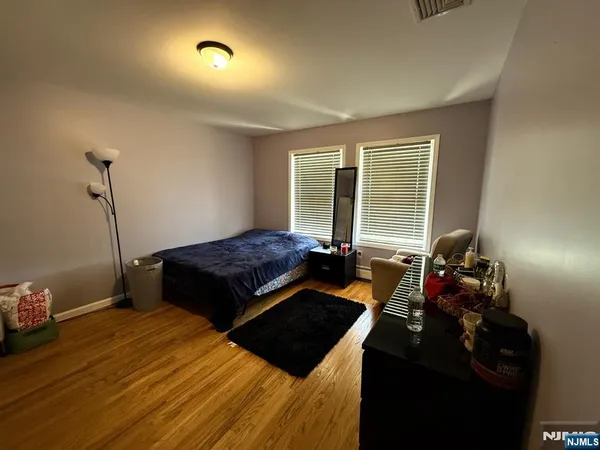 a bed sitting in a bedroom next to a window