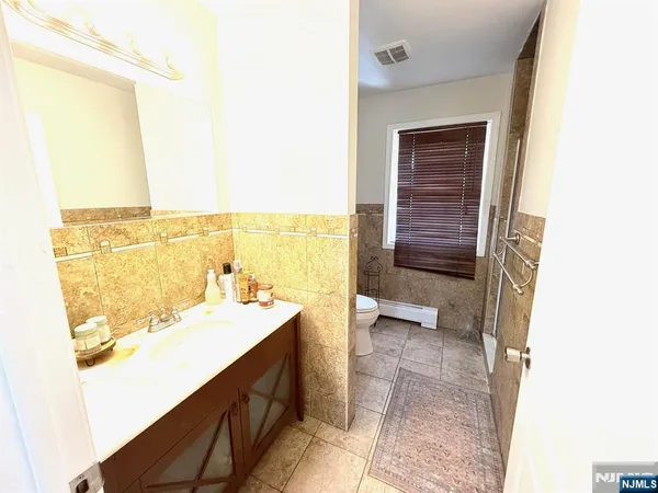 a bathroom with a sink a toilet and a tub