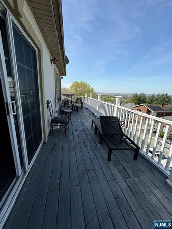 a view of balcony with wooden floor and outdoor seating