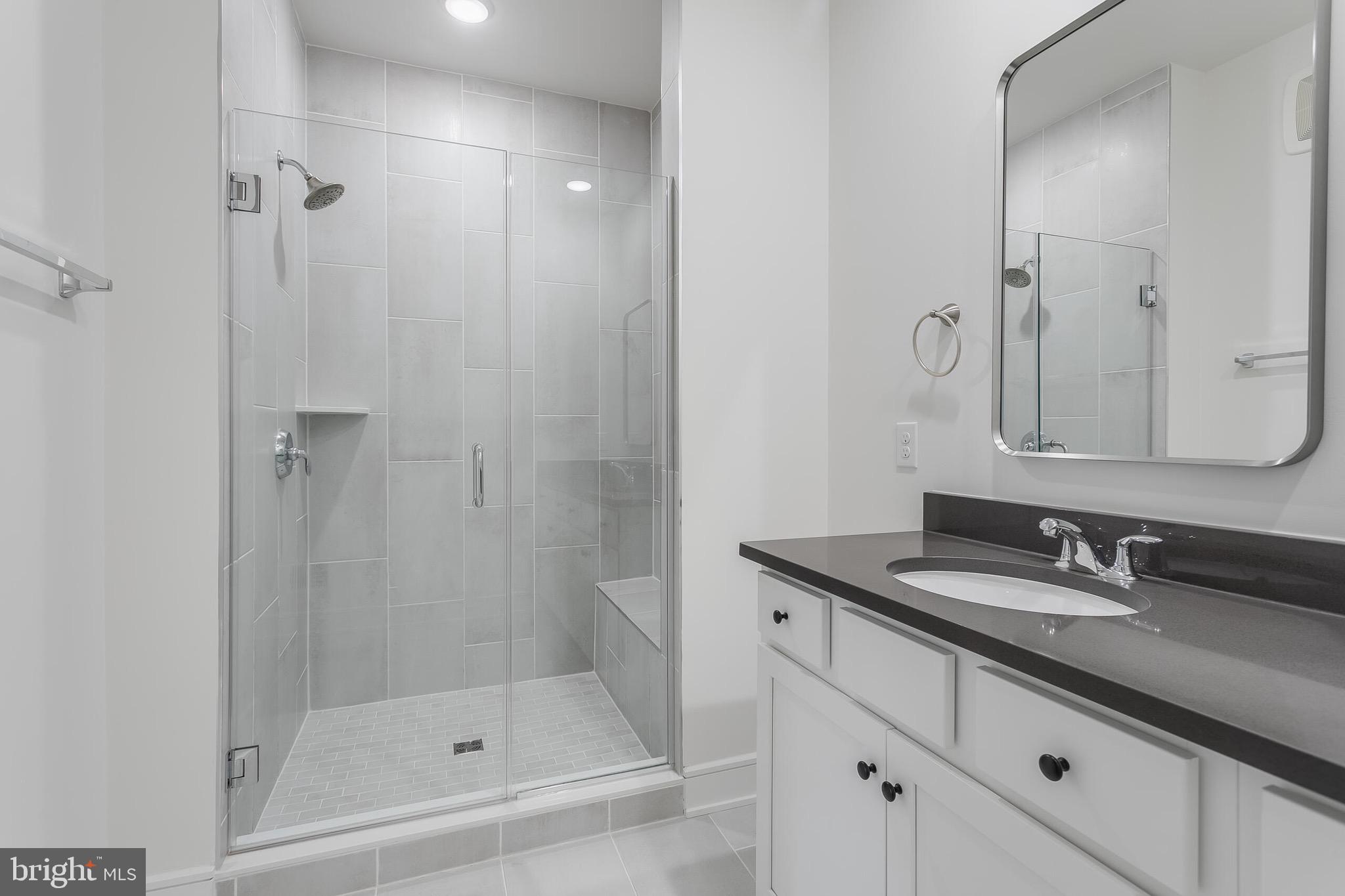 42708 Darala Drive Ashburn, VA 20147 - Photo 17 of 27 a bathroom with a granite countertop sink a mirror and a shower