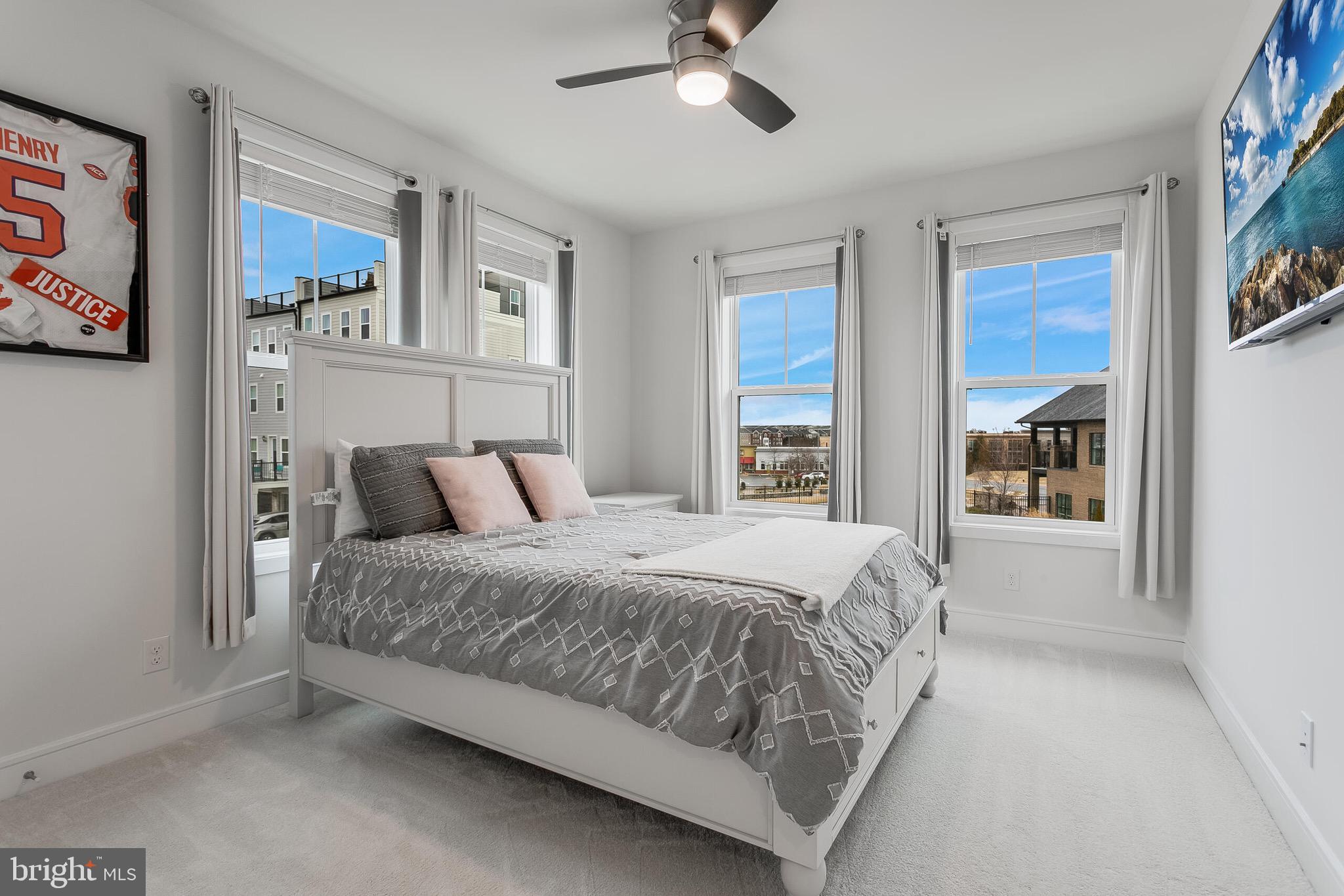 42708 Darala Drive Ashburn, VA 20147 - Photo 21 of 27 a spacious bedroom with a bed and glass windows