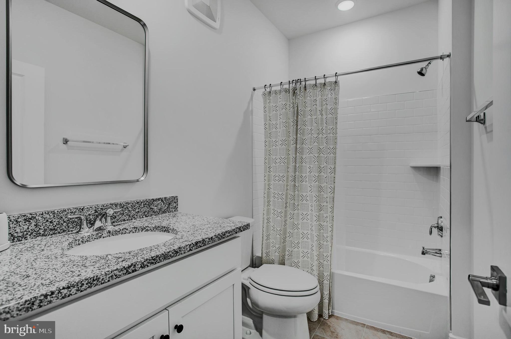42708 Darala Drive Ashburn, VA 20147 - Photo 23 of 27 a bathroom with a granite countertop sink a toilet and shower