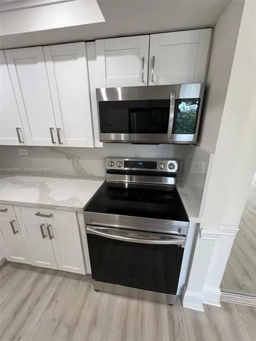 a kitchen with a stove and a microwave