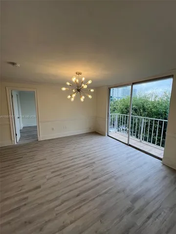 a view of a room with wooden floor and window