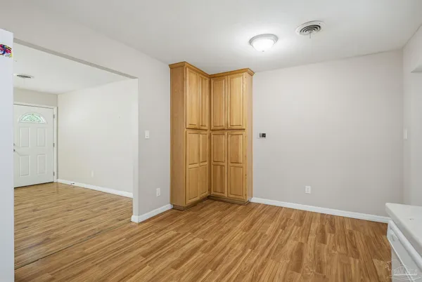 an empty room with wooden floor and a window