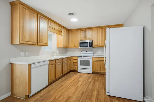 a kitchen with a refrigerator sink and microwave