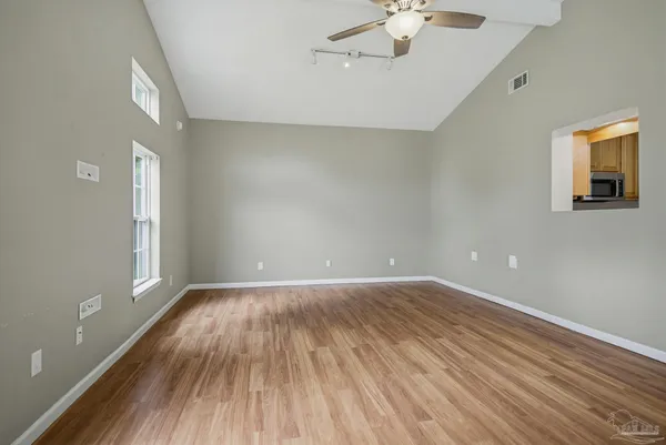 wooden floor in an empty room with a window