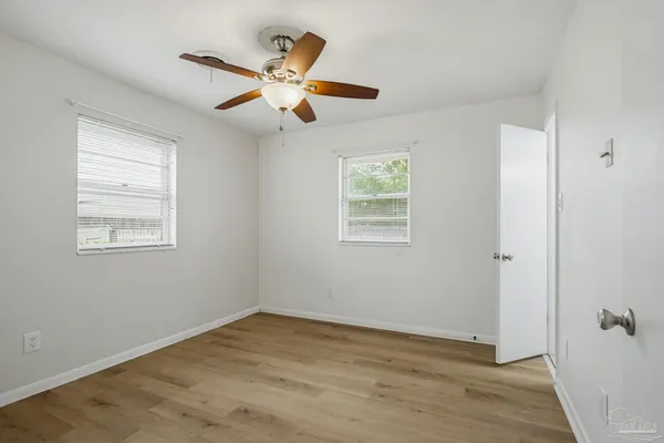 a view of a livingroom with a ceiling fan and window