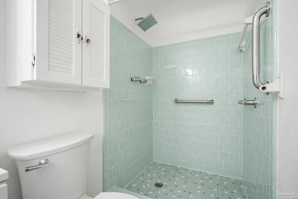 a bathroom with a shower a toilet and sink
