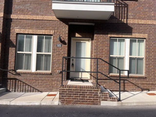 a view of a brick house with large windows