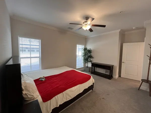 a bedroom with a bed dresser and a window