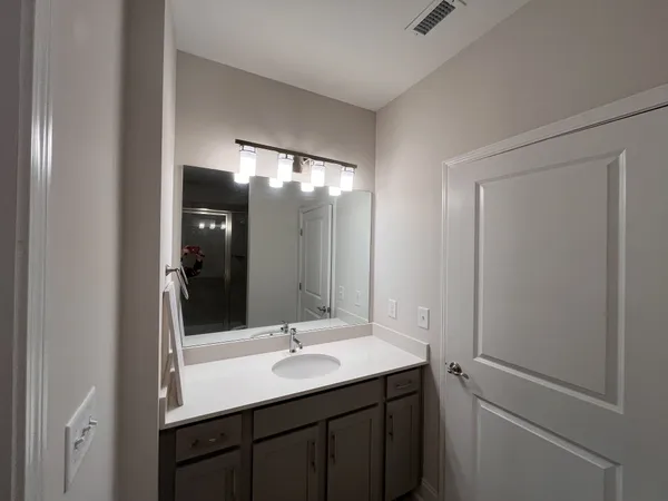 a bathroom with a double vanity sink and mirror