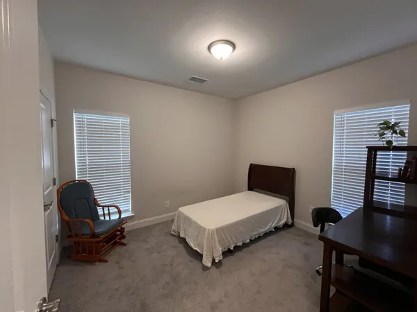 a bedroom with a bed and a desk