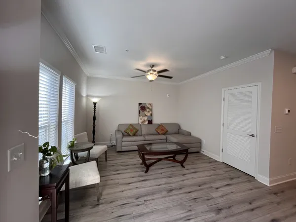 a living room with furniture and wooden floor