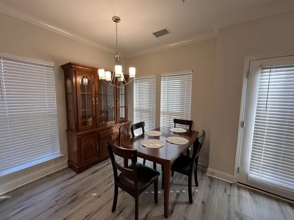 a view of a dining room with furniture and window
