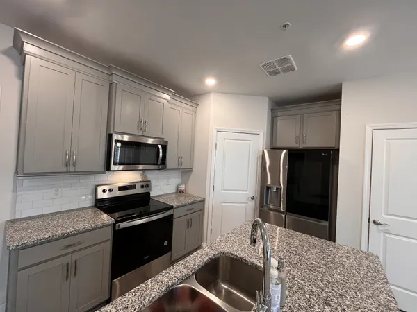 a kitchen with a refrigerator stove and microwave