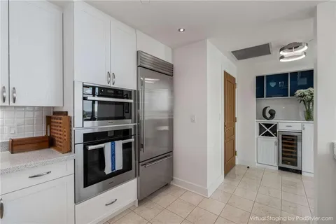 a kitchen with stainless steel appliances a stove a microwave and a refrigerator