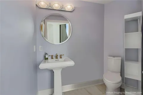 a bathroom with a sink toilet and a mirror