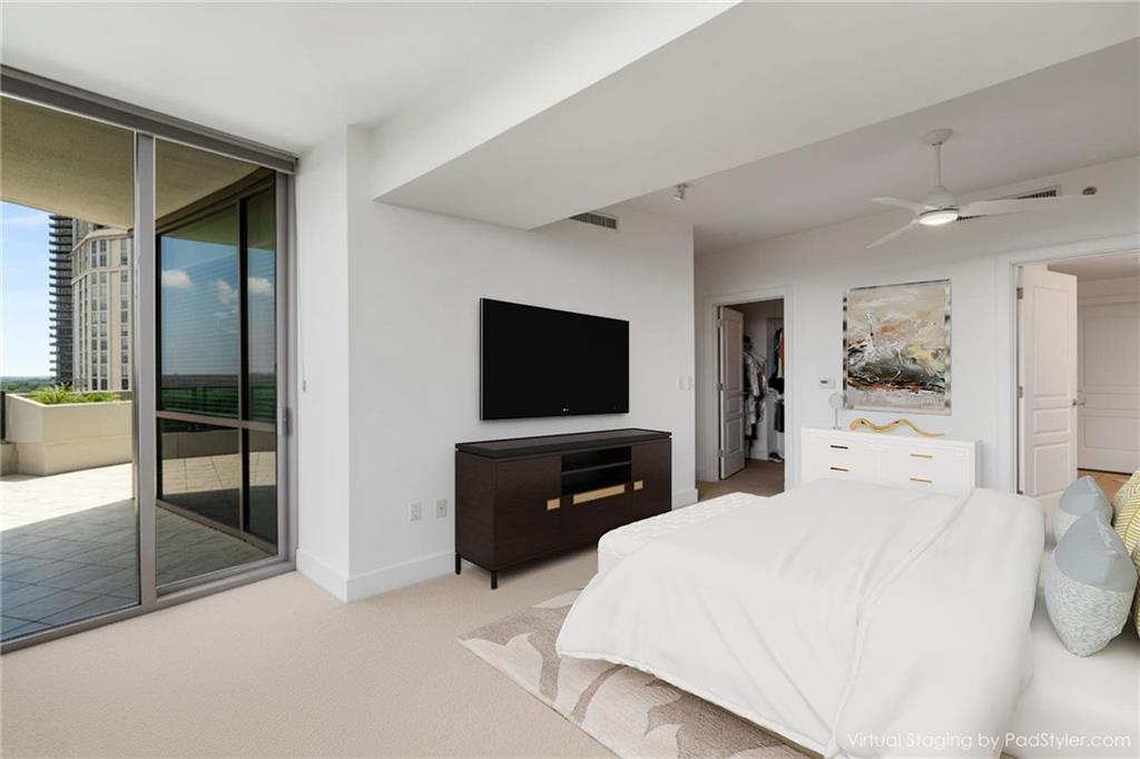 700 Park Regency Place Northeast, Unit 2201 Atlanta, GA 30326 - Photo 21 of 47 a bedroom with a bed and a flat screen tv