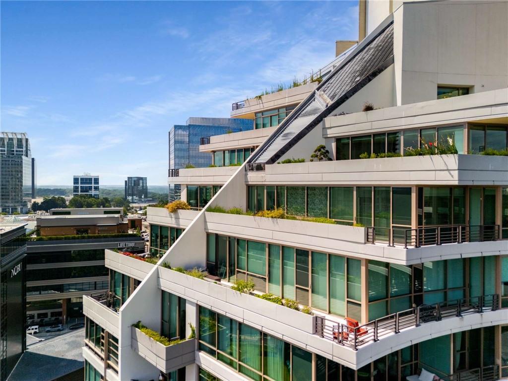 700 Park Regency Place Northeast, Unit 2201 Atlanta, GA 30326 - Photo 31 of 47 a house with tall trees in front of it