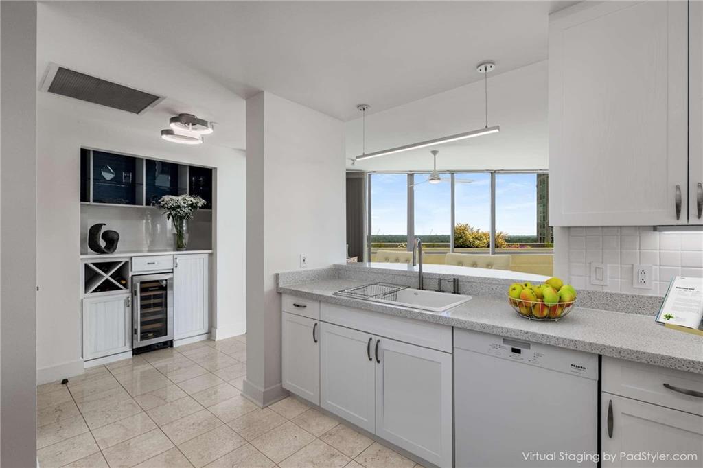 700 Park Regency Place Northeast, Unit 2201 Atlanta, GA 30326 - Photo 4 of 47 a kitchen with a sink white cabinets and stainless steel appliances