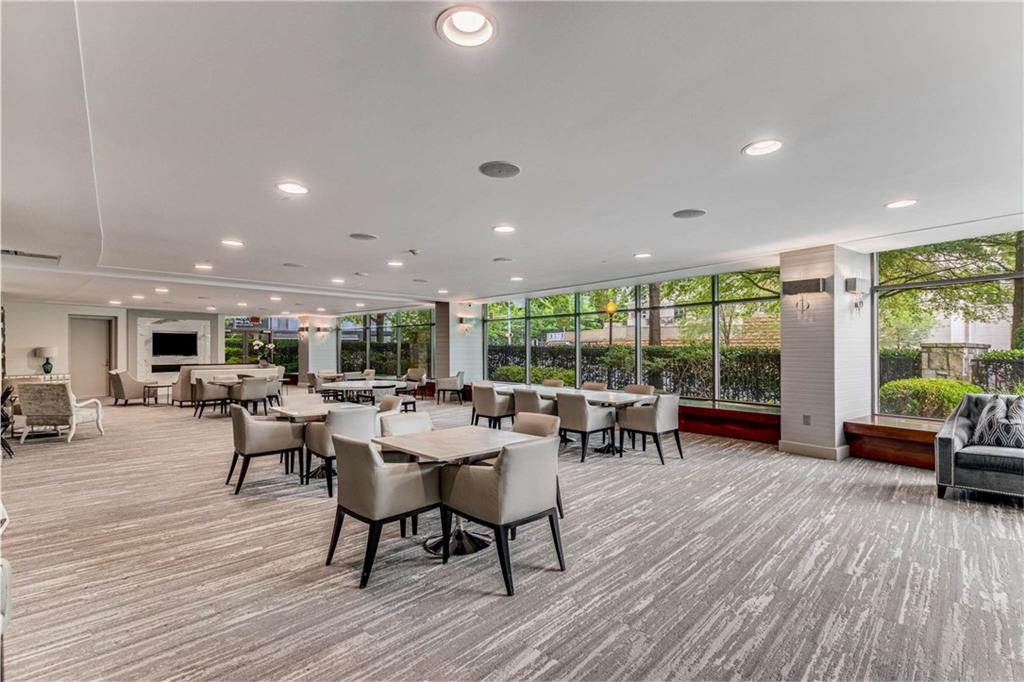 700 Park Regency Place Northeast, Unit 2201 Atlanta, GA 30326 - Photo 41 of 47 a living room with furniture and a wooden floor