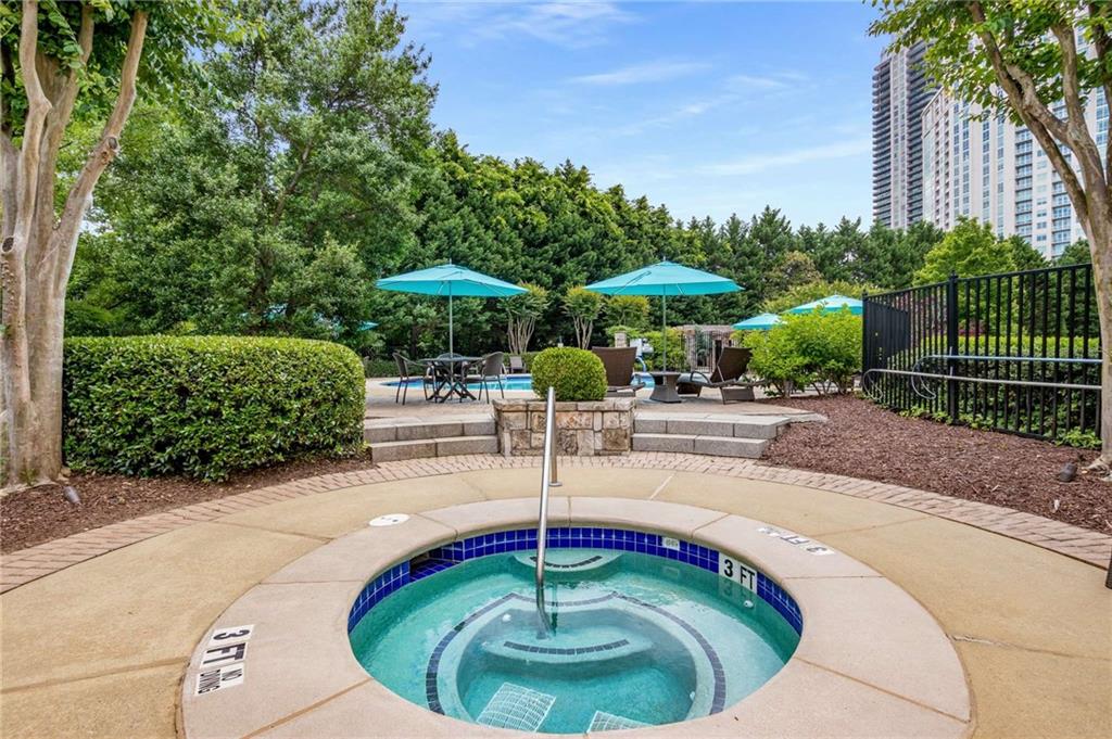 700 Park Regency Place Northeast, Unit 2201 Atlanta, GA 30326 - Photo 46 of 47 a swimming pool with outdoor seating yard and barbeque oven