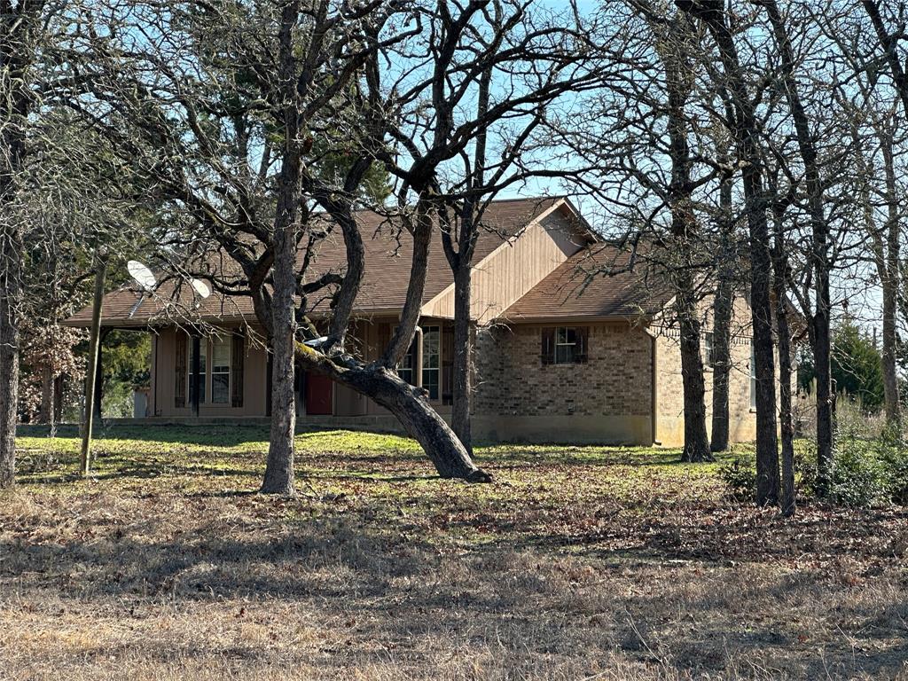 Set among nearly 14 acres of mature woods, this thoughtfully cared-for brick home offers the rare combination of privacy, space, and everyday comfort.