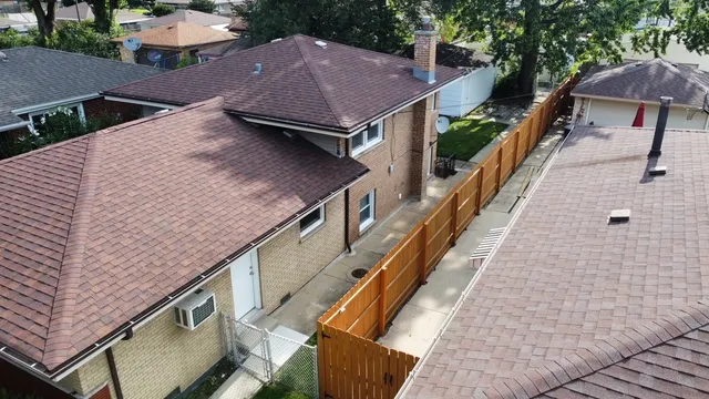 an aerial view of a house with a yard