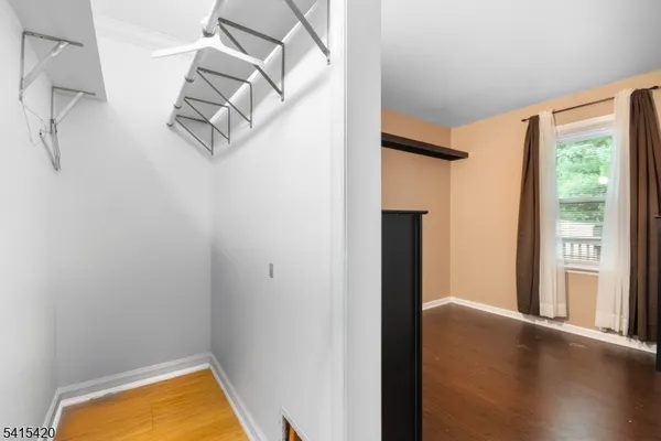 a view of a room with rack on the wall and a window