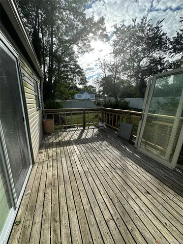 a view of balcony with wooden floor and bench