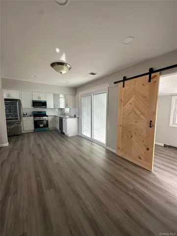 a view of kitchen with furniture and wooden floor