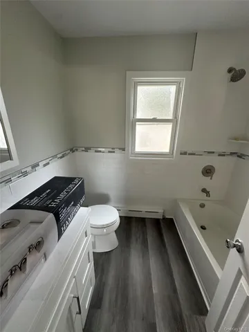 a bathroom with a sink a toilet and bathtub