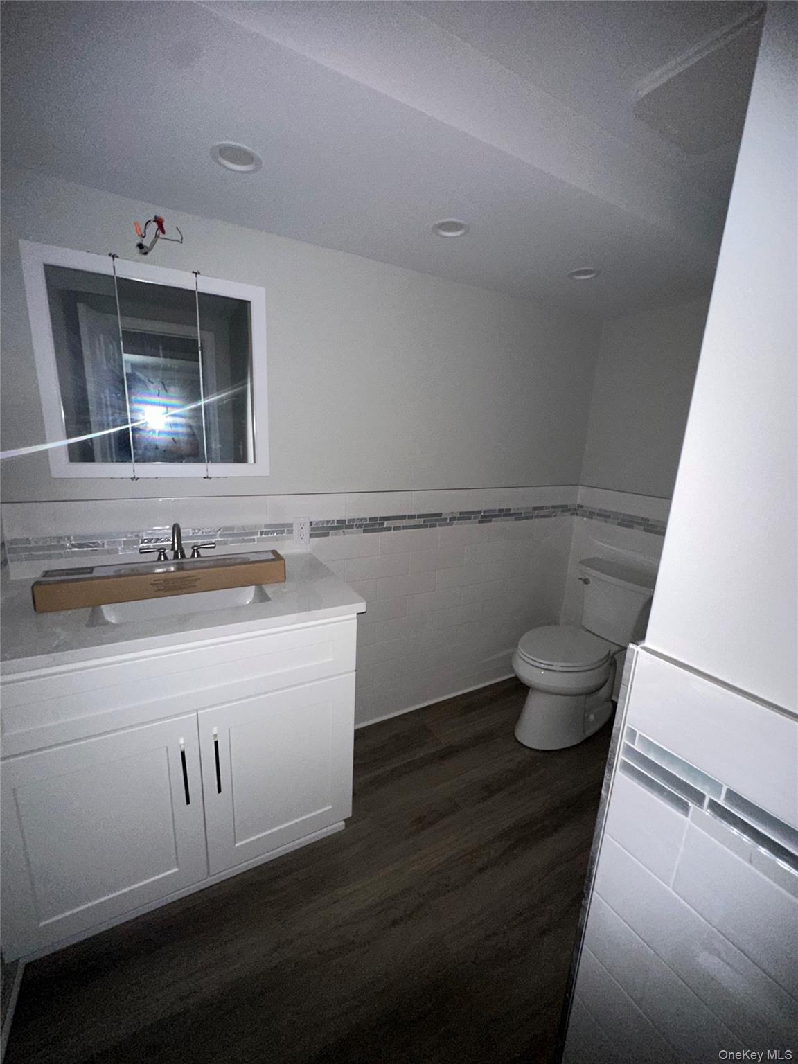 16 Blythe Road Ronkonkoma, NY 11779 - Photo 8 of 11 a bathroom with a sink and a mirror