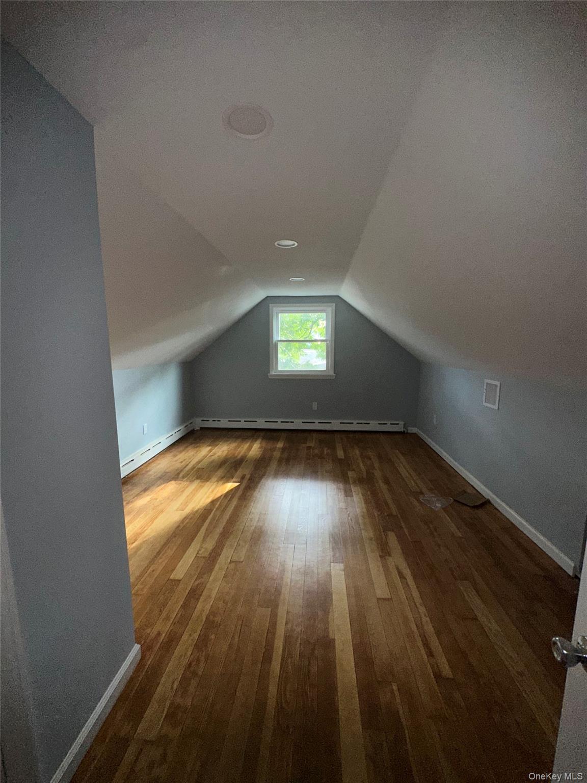 16 Blythe Road Ronkonkoma, NY 11779 - Photo 9 of 11 wooden floor in an empty room