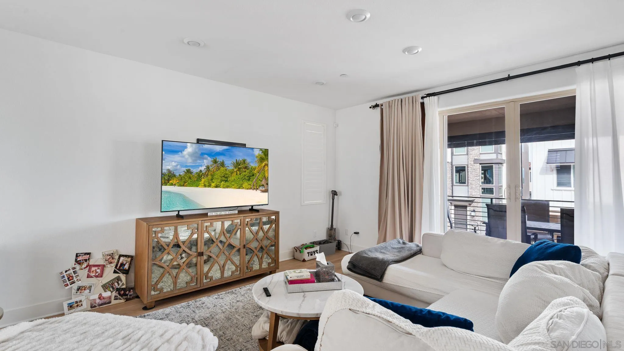 15681 Rennyson Way San Diego, CA 92129 - Photo 2 of 36 a living room with furniture and a flat screen tv
