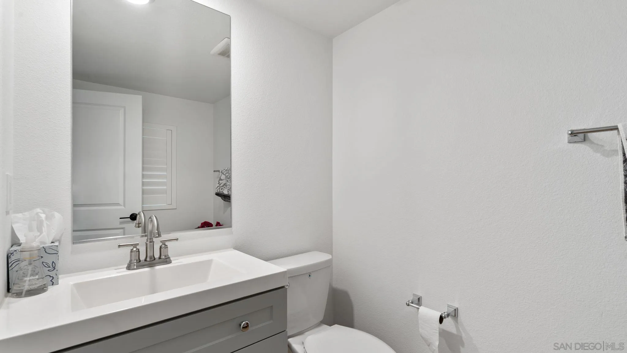 15681 Rennyson Way San Diego, CA 92129 - Photo 26 of 36 a bathroom with a sink mirror and toilet