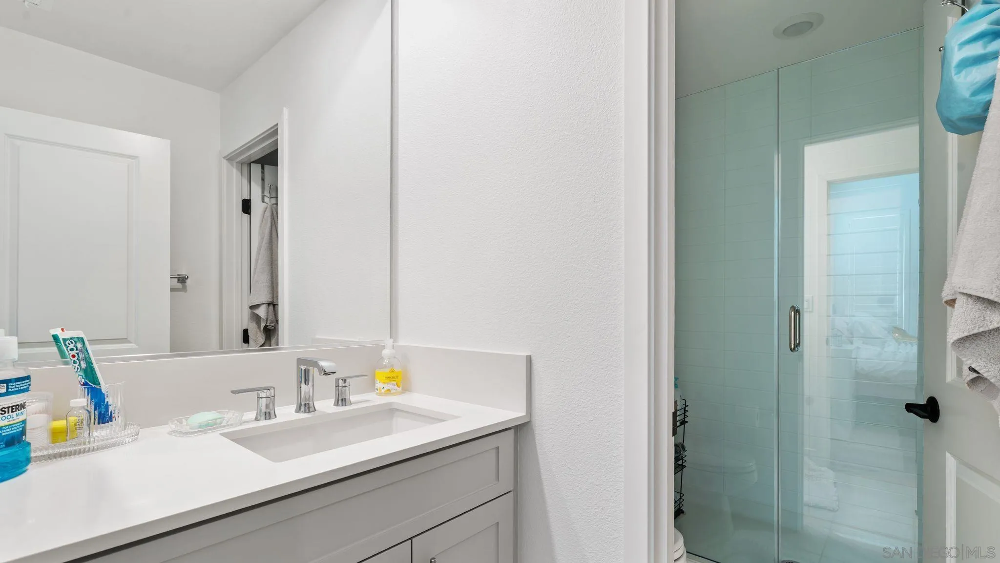 15681 Rennyson Way San Diego, CA 92129 - Photo 30 of 36 a bathroom with a sink and a mirror