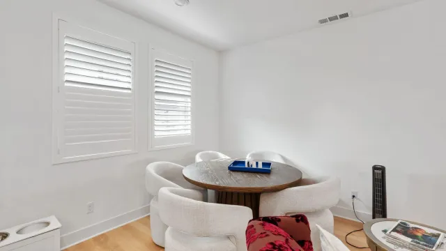 a dining room with furniture and window