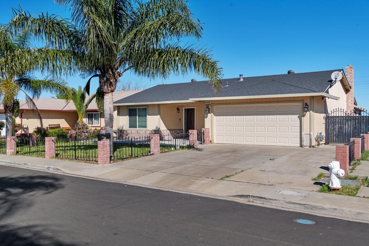 a view of a house with a patio and a yard